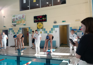 Uczniowie przygotowują się do startu podczas zawodów pływackich